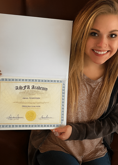 ASFA Facial Academy graduate holding a facial certificate